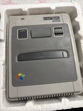 Super Nintendo Entertainment System (SNES) console, with game Street Fighter II.