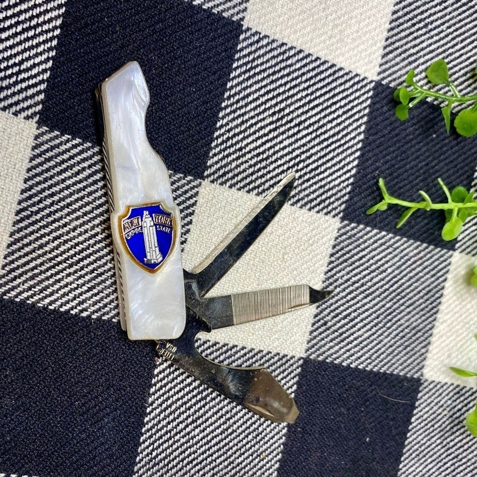 A pocket knife multi-tool shaped like the Empire State Building with mother-of-pearl inlay — kitschy New York souvenir energy meets actual useful EDC tool.