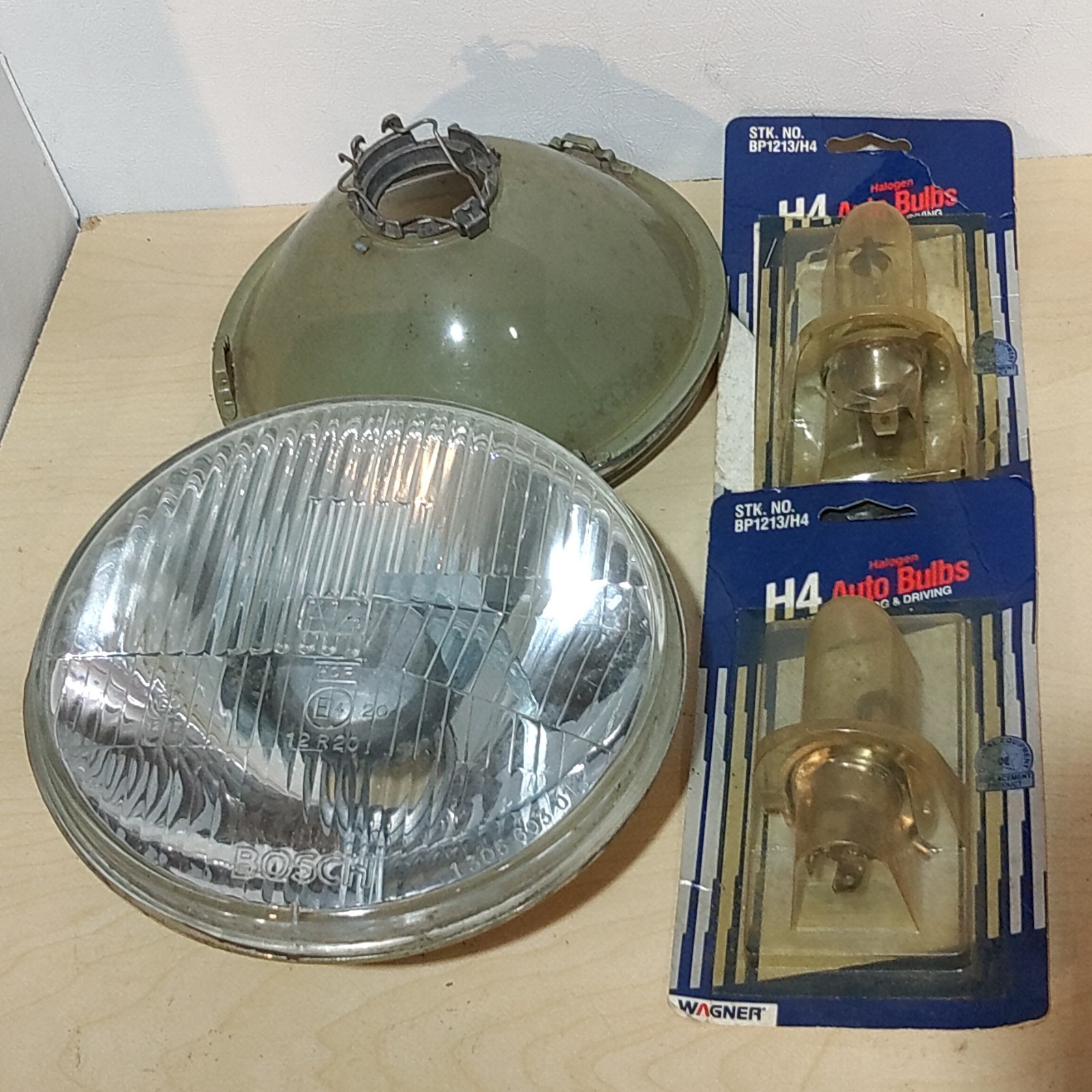 Set of 2 - Bosch 7 Headlight Lense 1305 603 012, with New HO BP1213/H4 bulbs.