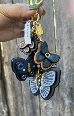 キーホルダー・キーリング COACH KEY FOB Butterfly Cluster 1674 COACH Butterfly Cluster Mix Bag Charm Keychain Gold / Denim
