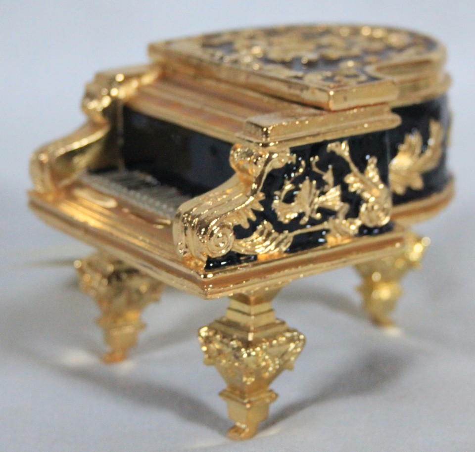 A wind-up miniature piano music box playing Chopin's Fantasie Impromptu — a charming desk piece that's functional, collectible, and conversation-starting.
