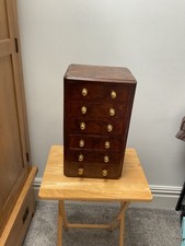 Minature chest of 6 drawers. 47cm x 20cm x27 cm. Wood veneer on drawer fronts.