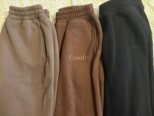 3 pairs of medium-comfort sweatpants in black and brown.