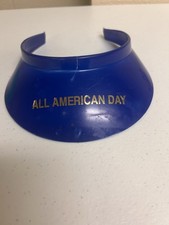 blue plastic clip-on sun visor with the gold text "ALL AMERICAN DAY".