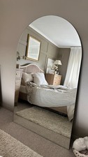 large frameless arched mirror