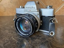 Minolta SRT 101 Film Camera With MC Rokkor-PF 1:7 55mm Lens And Leather Case.