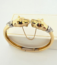 Bracelet jonc ouvrant en or jaune 18 carats , têtes de panthères