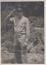 WW2 Photo of Soldier Giving Salute beside Tree Stump Background