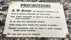 ANTIQUE WWII WW2 BRITISH MILITARY HOME GUARD AW BOMBS PRECAUTIONS ENAMEL SIGN.