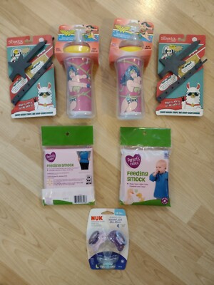 2 Sippy Cups, 2 Sippy Cup Hand Holders, 3pk Nuk Pacifiers, 2 Pink Bibs. All NEW.