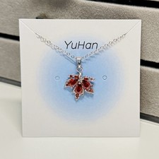 Red maple leaf pendant with silver trim &adjustable stainless steel necklace.