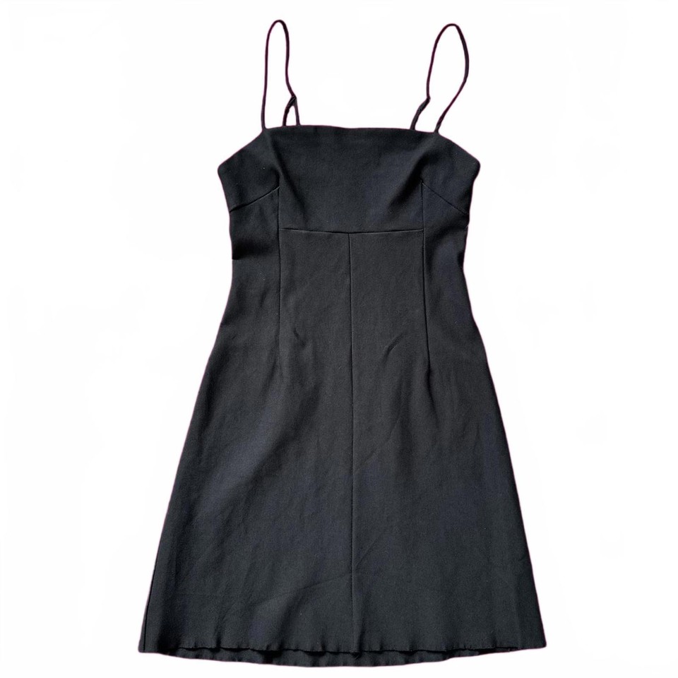 Black mini slip dress with thin adjustable straps and clean seam detailing.