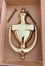 A polished brass door knocker, Baldwin, No. 0108