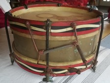 Two antique brass military marching drums, one made by Hawkes and Son, London.