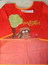 BLOUSE/TABLIER PVC ORANGE 5/6 ANS NEUF