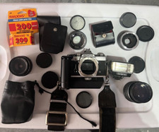 olympus om-1 camera with multiple lenses