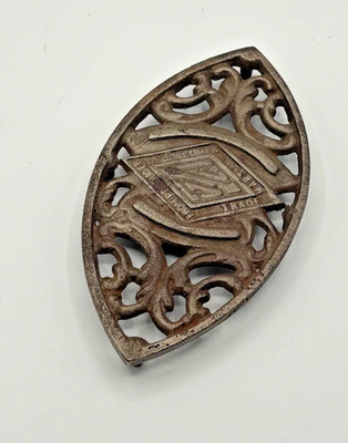 Antique Rosenbaum 'Uneedit' Cast Iron Sad Iron Trivet Football Shape