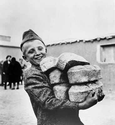 Polish youngster smiles arms loaded down bread made flour supplied - Old Photo