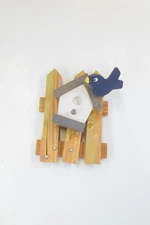 WOODEN BIRD FEEDER ON FENCE. 3.5 X 5.5 INCHES. SOLD AS IS.