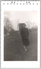 Vtg B&W Snapshot Woman Windmill Overcoat Outdoors 1950s