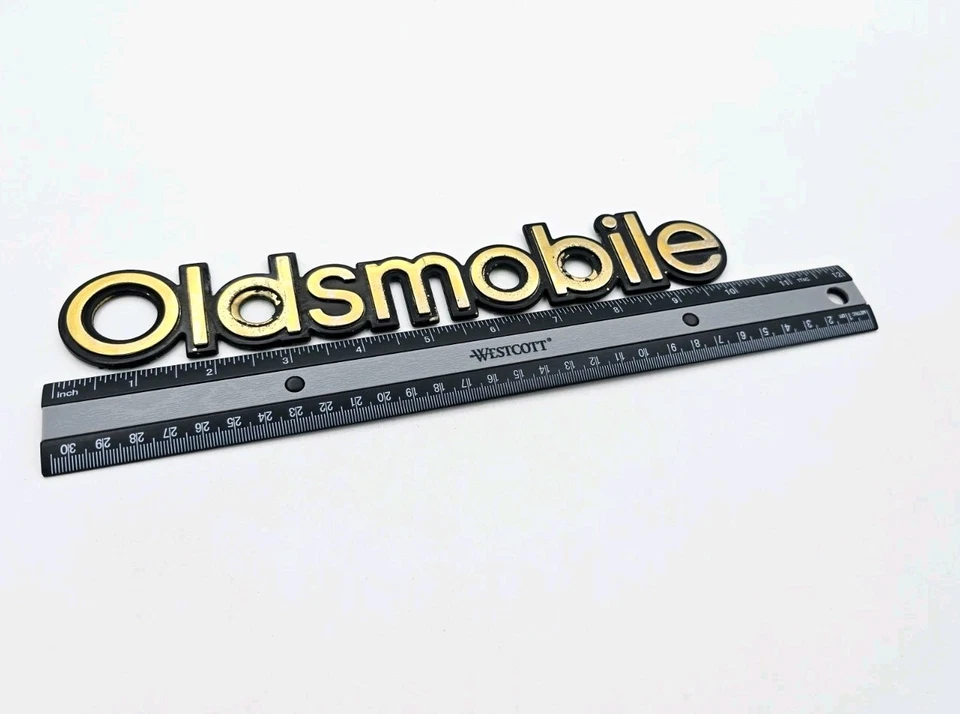 Oldsmobile Bravada 1996-2001 letras trak inteligentes símbolo signo logotipo emblema oro OEM Foto 2 de 3