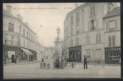 Old postcard Livry, Rue de l'Église et la Mairie with a fountain in the center 