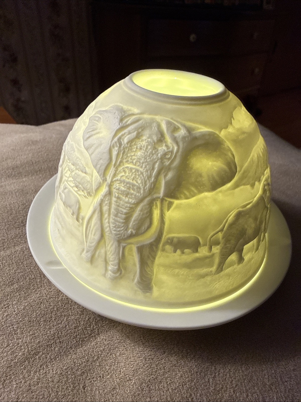 W/candle With Elephants Around It