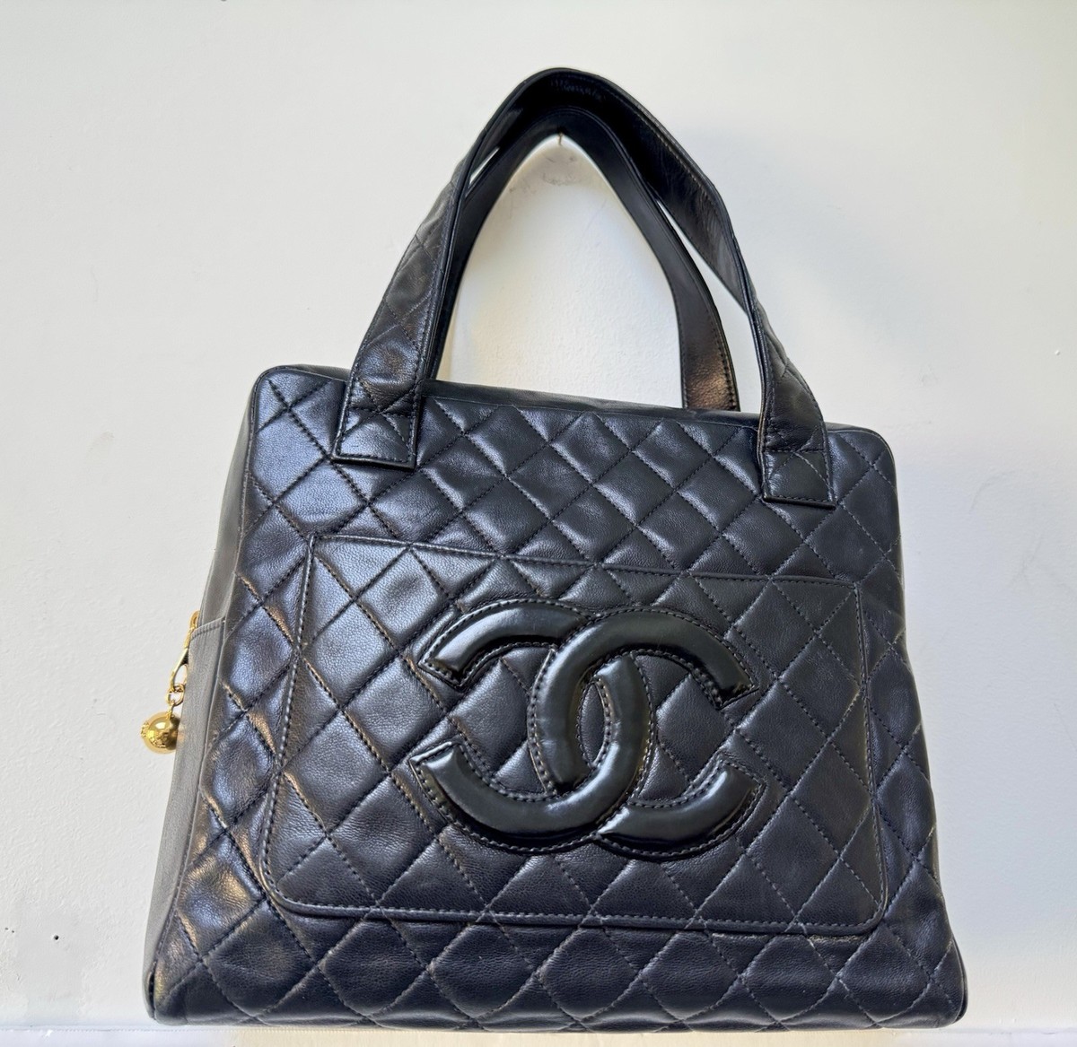 This is a classic CHANEL handbag in sleek black, crafted 1997