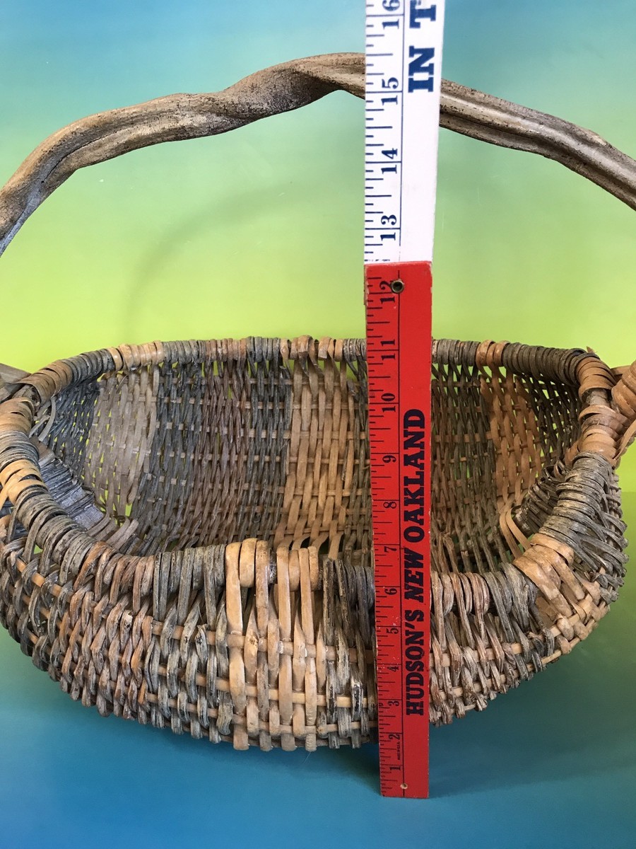This vintage hand-woven buttocks egg gathering basket is a unique