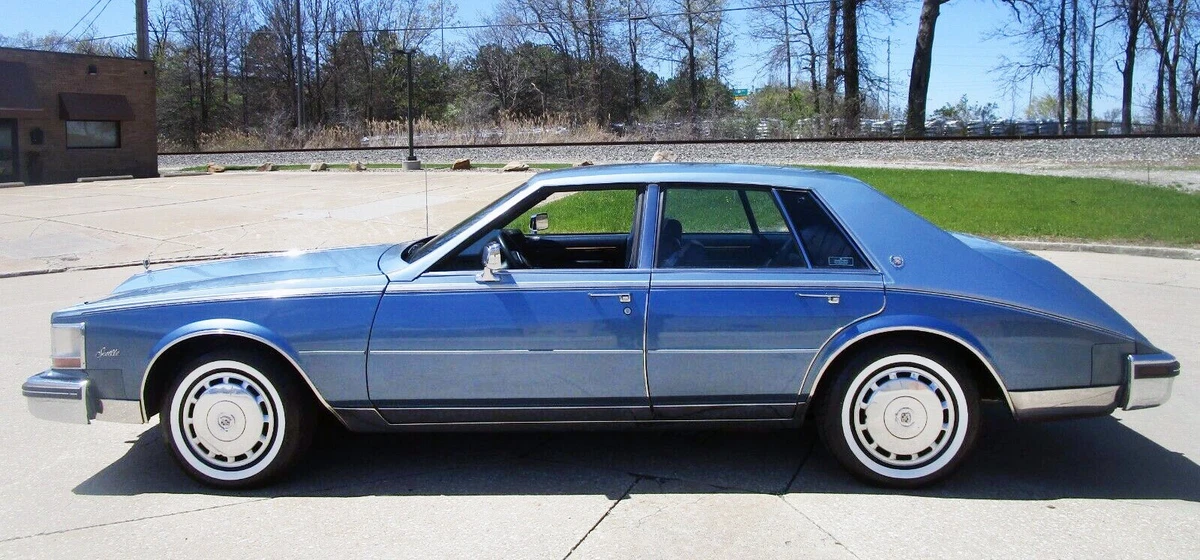 blue second-generation cadillac seville from 1985, diver side exterior view