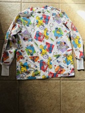 A Sesame Street character print long-sleeve scrub top by Crest Brand.