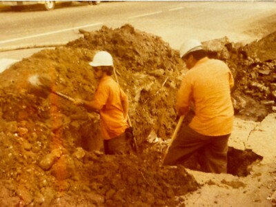 2S Photograph Construction Worker Digging Holes In Street Orange Shirts 1978