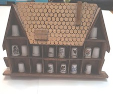 thimble storage shelf in shape of house. with selection of thimbles 19cm by 30cm