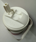 White vintage NWT Igloo 1/2 gallon cooler with black lid, side handle, and embossed logo on top.