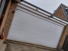 White Electric Double Garage Door with Controls and Mechanisms