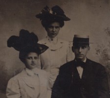 PORTRAIT OF YOUNG MAN   TWO BEAUTIFUL WOMEN, ALL IN HATS W/ PAINTED BACKDROP