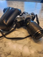 Canon AE-1 SLR 35mm Film Camera W/ 75-200mm 1:4.5 lens and case.