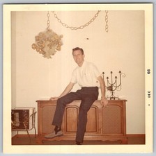Vtg Color Snapshot Handsome Smiling Man Sitting On Credenza Stereo Console 1966