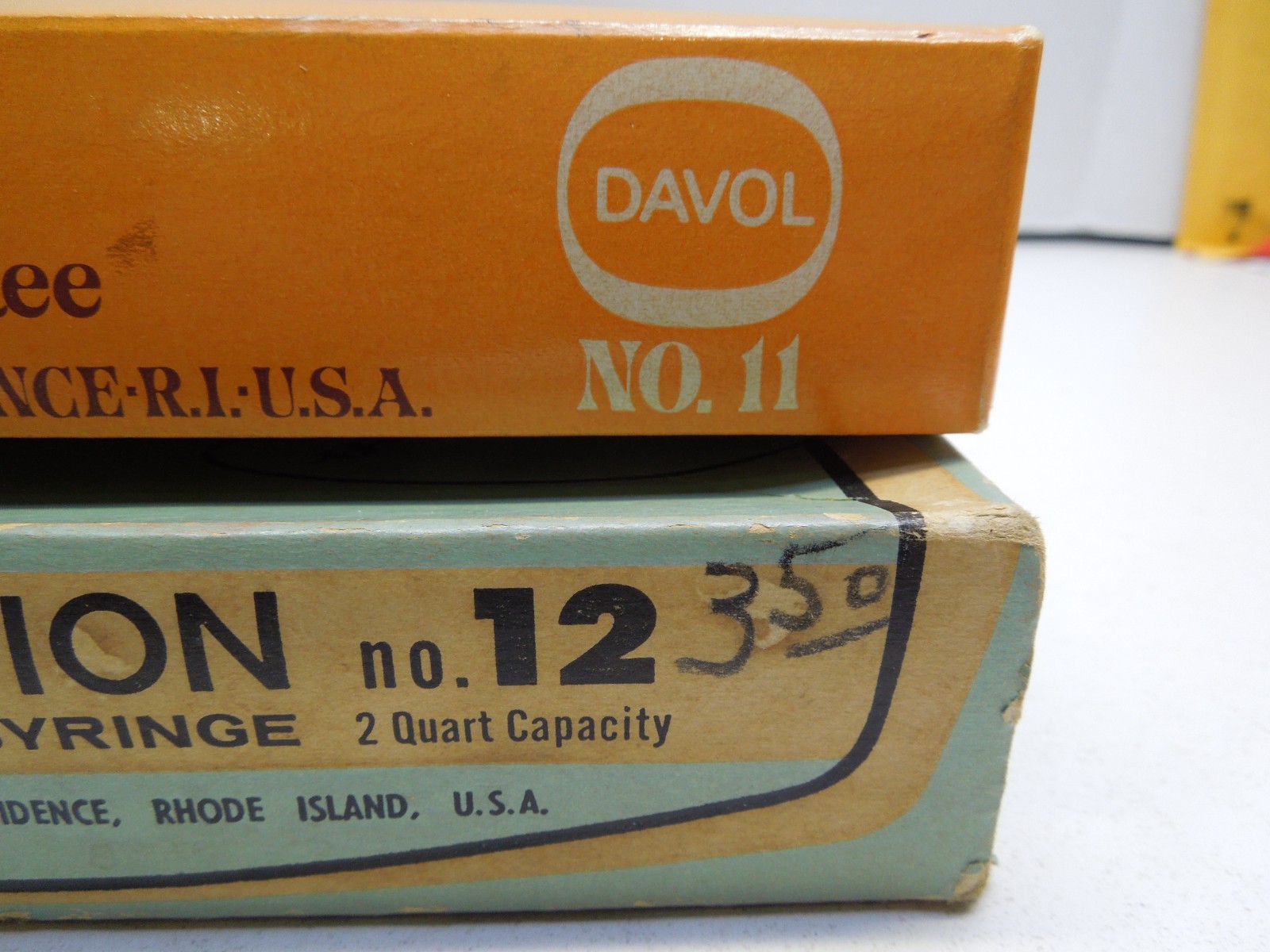 A PAIR of VINTAGE DAVOL COMFY WATER BOTTLE/SYRINGE COMBINATION #12