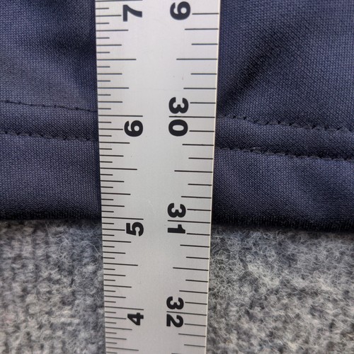 Blue full zip jacket with white stitching, 2XL size, shown against a gray fabric tape measure on a light wooden surface.