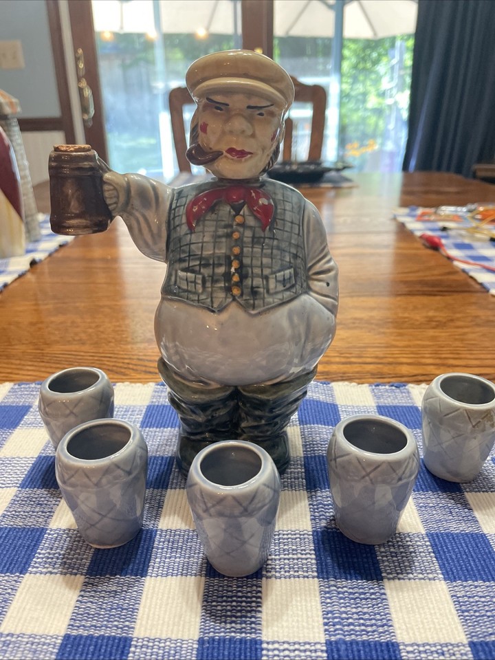 A RELCO ceramic decanter set shaped around golfing, sea dog, and Scotsman characters with shot glasses — the kind of kitschy mid-century bar set that's equal parts absurd and brilliant.