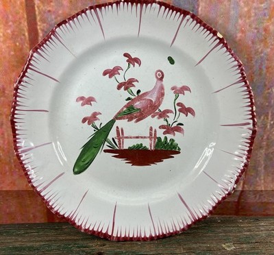 EASTERN FAIENCE PLATE FROM LES ISLETTES, DECORATED WITH A PEACOCK ON A FENCE