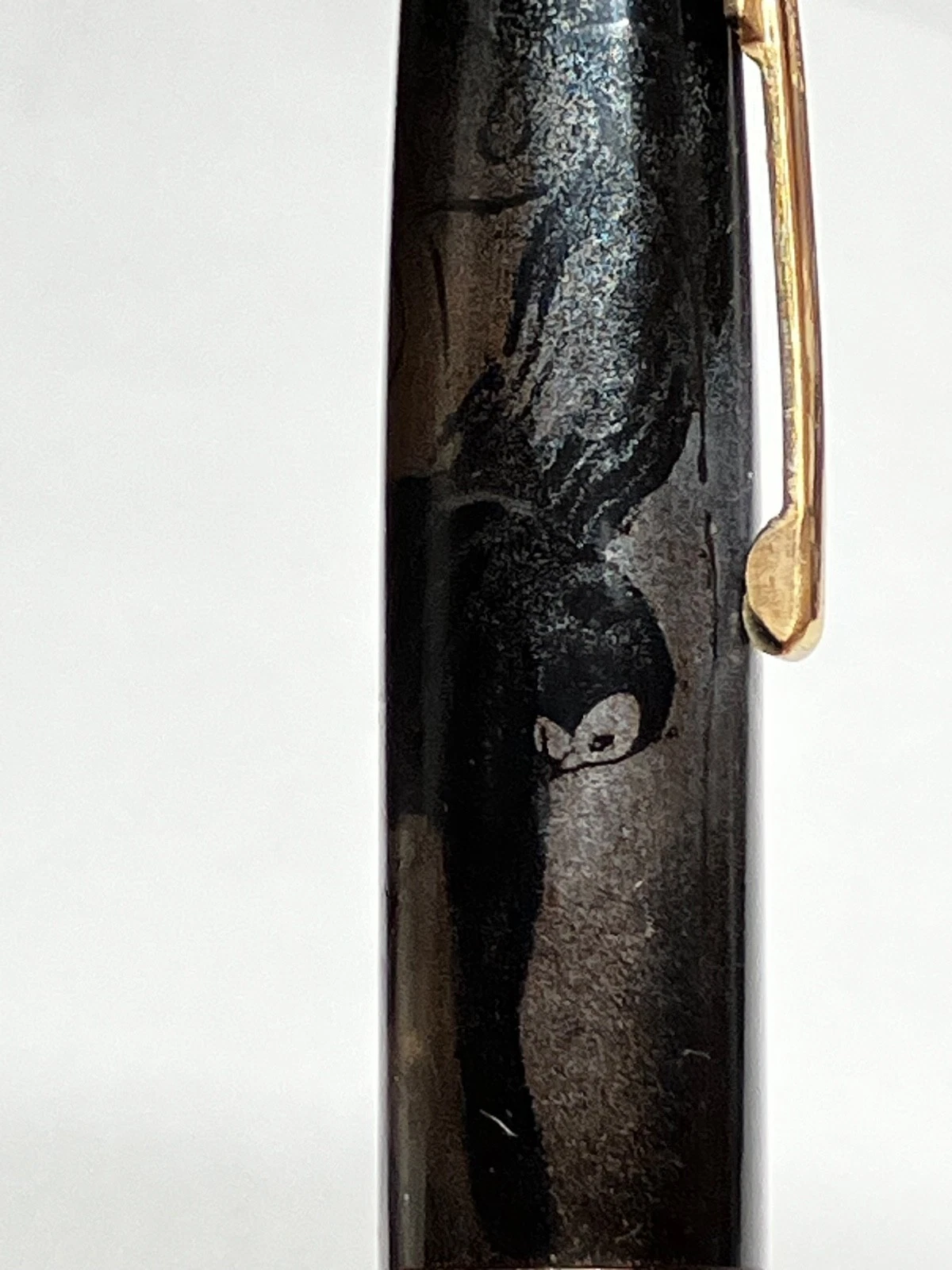 Vintage black ink shut off fountain pen with gold nib, urushi maki-e style, featuring faint bird and tree design on barrel.