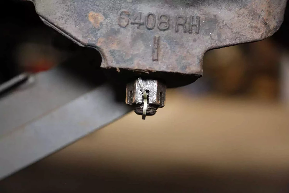 A new cotter pin is installed in the castle nut.