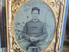 Civil War soldier sitting in front of a military camp backdrop 1/4 plate tintype