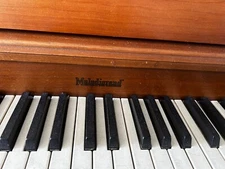 Melodigrand upright piano with bench. Excellent condition, just needs a tuning.