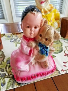 baby holding teddy bear