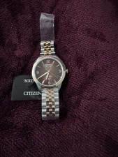 This elegant Citizen Eco‑Drive features a rich brown sunburst dial, gold accent