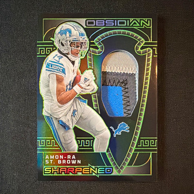 Panini 2023 Obsidian Sharpened Swatches Amon-Ra St. Brown SSW-AST /25 MEM