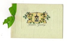 Season's Greetings holiday card on green stock bound with green satin ribbon 